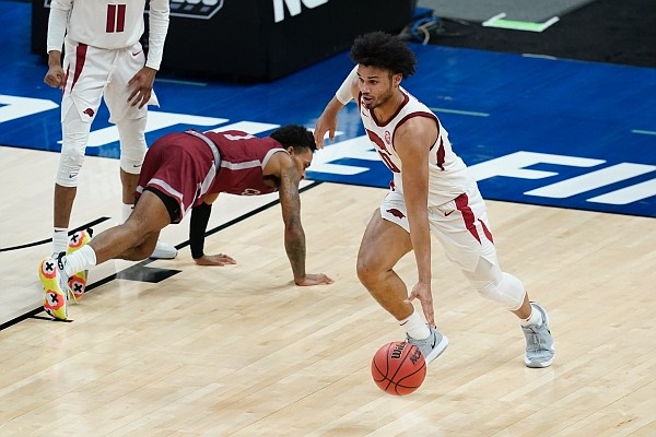 Arkansas' Justin Smith (0) dribbles during the second half of a first round game against Colgate at Bankers Life Fieldhouse in the NCAA men's college basketball tournament, Friday, March 19, 2021, in Indianapolis. (AP Photo/Darron Cummings)
