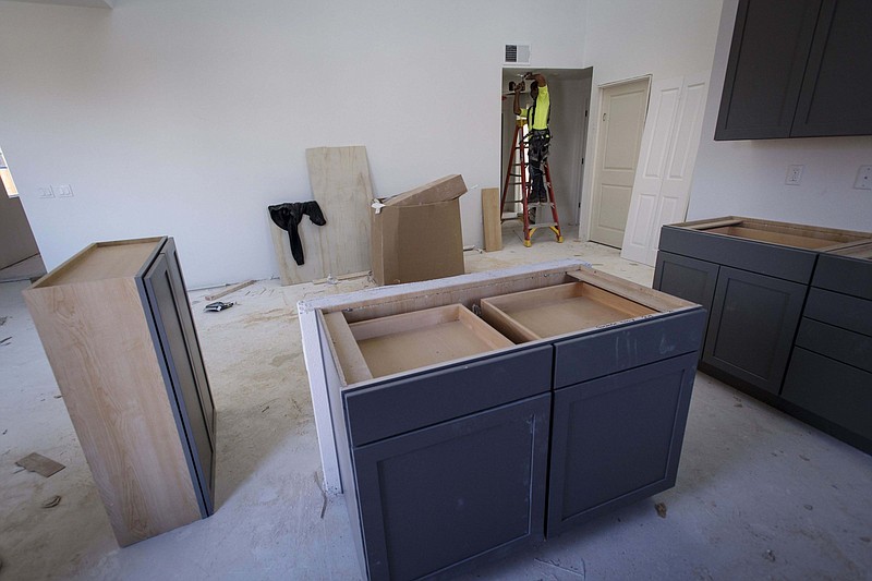 A contractor installs a smoke detector in a townhouse under construction at the PulteGroup Inc. Metro housing development in Milpitas, Calif., in this 2018 photo. The number of homes for sale is at its lowest since at least 1999 and that is encouraging investors to buy up older or derelict properties and fix them up for resale.
(Bloomberg News WPNS/David Paul Morris)