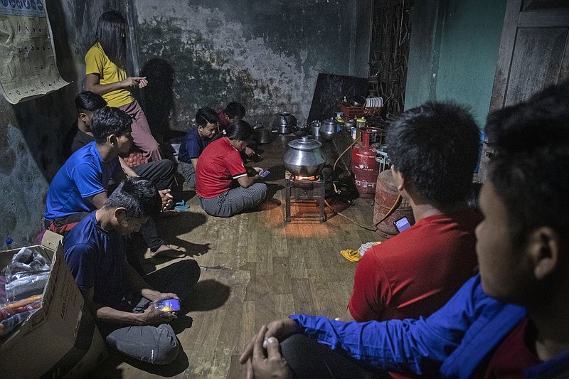 Police officers who fled Burma after a military coup sit for a meal Thursday at an undisclosed location bordering Burma in the northeastern Indian state of Mizoram.
(AP/Anupam Nath)