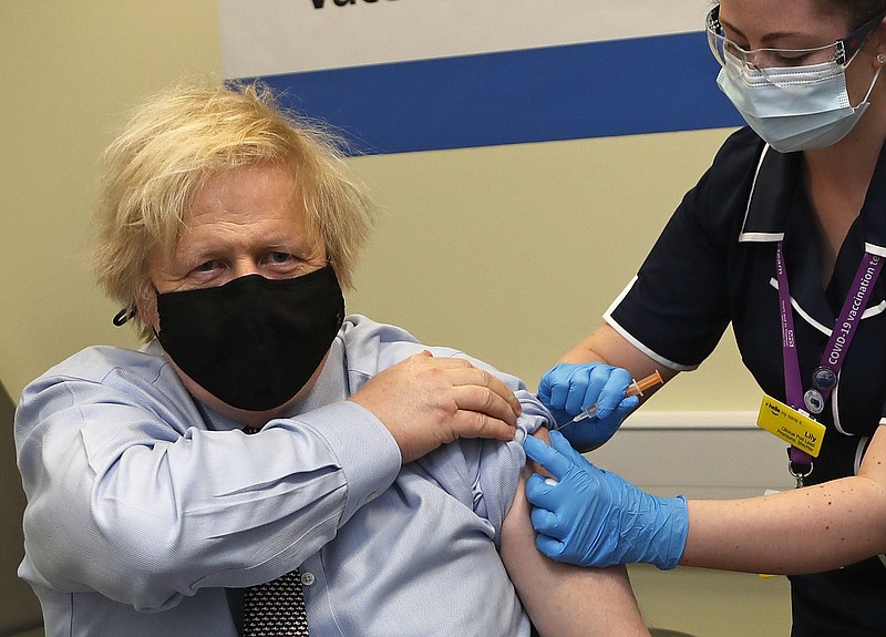 British Prime Minister Boris Johnson receives his first dose of the AstraZeneca vaccine administered by nurse Lily Harrington at St. Thomas’ Hospital on Friday in London. Johnson was treated at St. Thomas’ when he was ill last year with covid-19.
(AP/Frank Augstein)