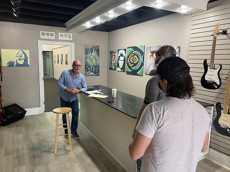 Kevin Barker speaks to guests as they peruse his new music store, Vintage Sound. Set to open in May, Barker said that the store will host a variety of musical instruments and equipment. (Rhett Gentry/Banner-News)