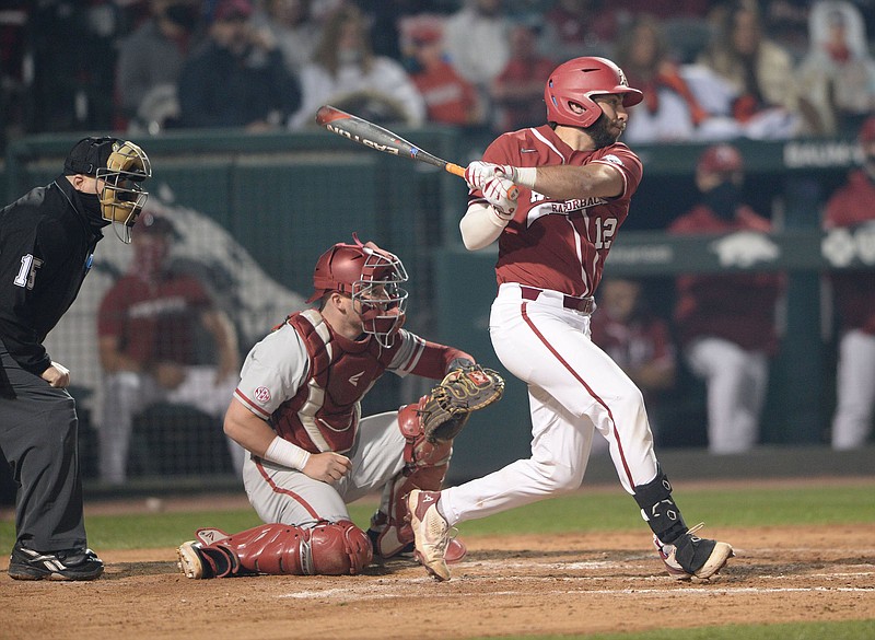 Arkansas catcher Casey Opitz follows through on an RBI double that scored Brady Slavens on  Saturday during the sixth inning of the Razorbacks’ 9-1 victory over the Alabama Crimson Tide  at Baum-Walker Stadium in Fayetteville. Opitz went 3 for 4 with 2 RBI and 3 runs scored for the  Razorbacks. More photos at arkansasonline.com/321alaua/.
(NWA Democrat-Gazette/Andy Shupe)