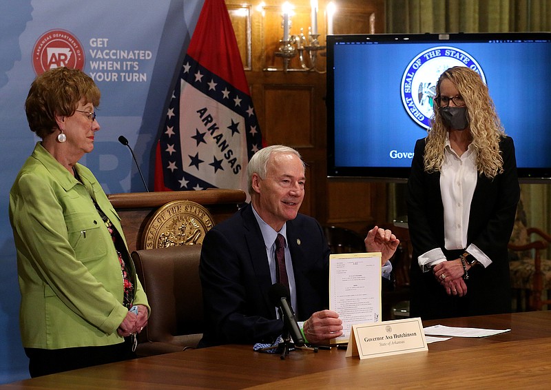 Gov. Asa Hutchinson talks about SB107, requiring computer science classes to graduate high school, as the bill's cosponsors, Sen. Jane English (left), R-North Little Rock, as Rep. DeeAnn Vaught (right), R-Horatio, look on Tuesday, March 23, 2021, at the state Capitol in Little Rock. .(Arkansas Democrat-Gazette/Thomas Metthe)