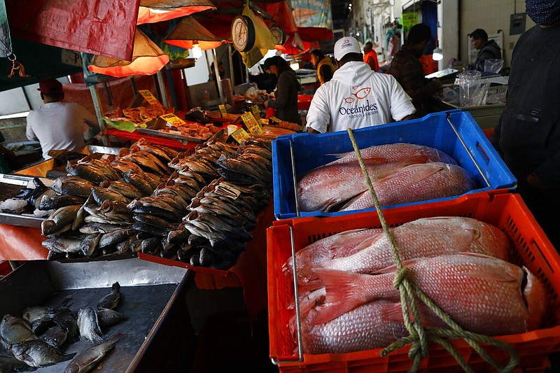 A worker pulls a cart with an order of red snapper for a client at the La Nueva Viga seafood market in Mexico City in this Dec. 9, 2020, file photo. (AP/Rebecca Blackwell)
