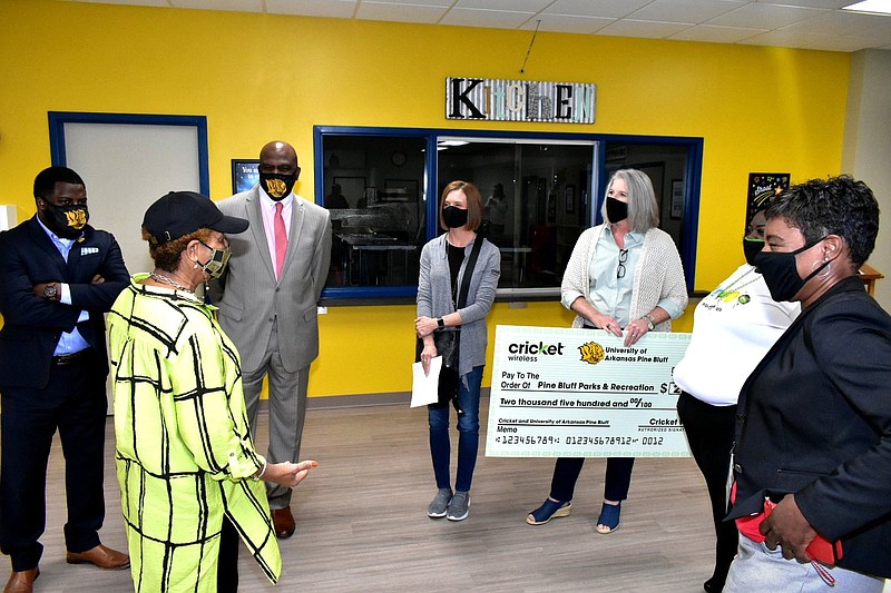Pine Bluff Mayor Shirley Washington (second from left) speaks with UAPB athletics and Cricket Wireless officials after a check presentation at the Pine Bluff Community Center on Wednesday. Also pictured: UAPB director of community outreach Cameo Stokes (from left), UAPB interim Athletic Director Chris Robinson, Cricket marketing manager Hayley Schaberg, Cricket indirect sales executive Beth Burgess, Cricket Olive Street store manager Meia Hellums and assistant to the mayor Cynthia Anderson. 
(Pine Bluff Commercial/I.C. Murrell)