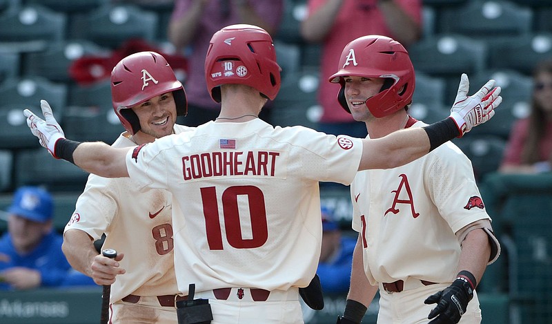 Arkansas’ Matt Goodheart is met at home plate by teammates Braydon Webb (left) and Cayden Wallace after hitting a two-run home run in the sixth inning of the Razorbacks’ victory over Memphis on Wednesday at Baum-Walker Stadium in Fayetteville. Goodheart finished 4 of 5 from the plate. See more photos at arkansasonline.com/325baseball.
(NWA Democrat-Gazette/Andy Shupe)