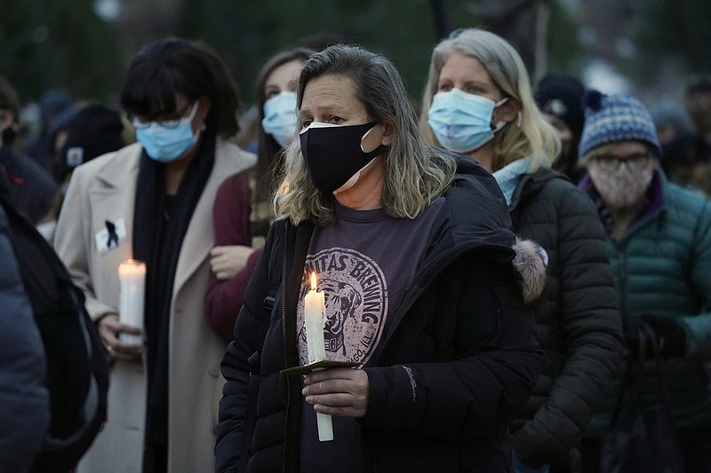 Mourners listen to speakers at a vigil for the 10 victims of the Monday massacre at a King Soopers grocery store late Thursday, March 25, 2021, at Fairview High School in Boulder, Colo. (AP Photo/David Zalubowski)