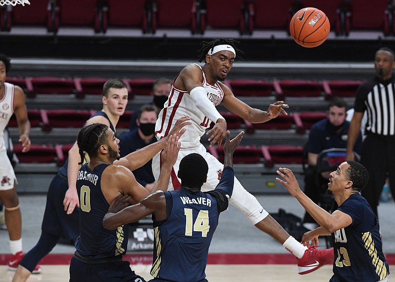 Jalen Tate of Arkansas makes a pass under pressure against Oral Roberts during their December 2020 matchup, which the Razorbacks won 87-76. Arkansas will take on Oral Roberts in the NCAA Tournament Sweet 16 on Saturday, marking the ninth time the Razorbacks have faced a team in the NCAA Tournament that it also met during that regular season.
(NWA Democrat-Gazette/J.T. Wampler)