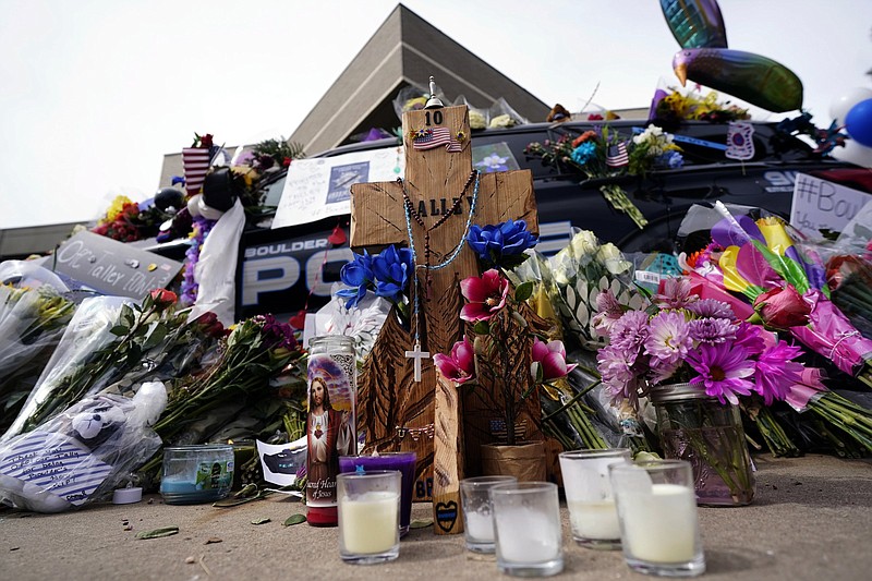 Tributes Thursday cover a police cruiser that was driven by slain officer Eric Talley in Boulder, Colo.
(AP/David Zalubowski)
