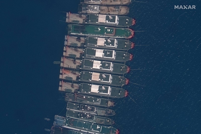 A satellite image shows Chinese vessels at anchor Tuesday on the Whitsun Reef in the disputed South China Sea. Philippine officials are sending more ships to the area as China ignores demands to move the vessels away.
(AP/©2021 Maxar Technologies)