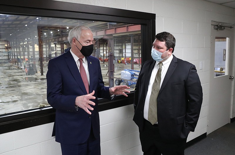 Gov. Asa Hutchinson (left) talks Friday with FiberPro founder and chief executive Josh Krauss at the company’s new plant in Hot Springs.
(The Sentinel-Record/Richard Rasmussen)
