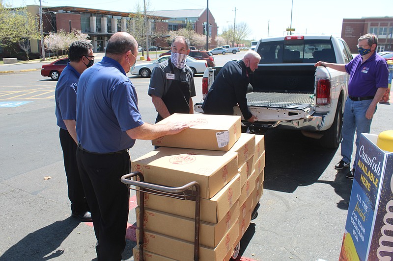 Salvation Army of El Dorado Cpt. Jason Perdieu visited the Brookshires on South West Avenue Friday to collect 154 hams donated by the stores and Hormel. (Matt Hutcheson/News-Times)