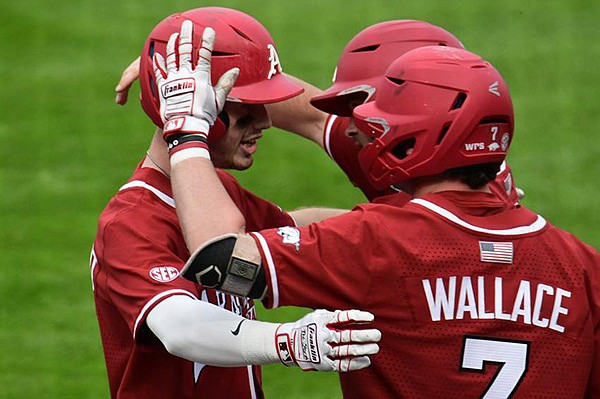 Arkansas designated hitter Matt Goodheart (left) is greeted by teammates after hitting a home run during a game against Mississippi State on Saturday, March 27, 2021, in Starkville, Miss. (Courtesy photo via Aaron Fitt/D1Baseball.com)