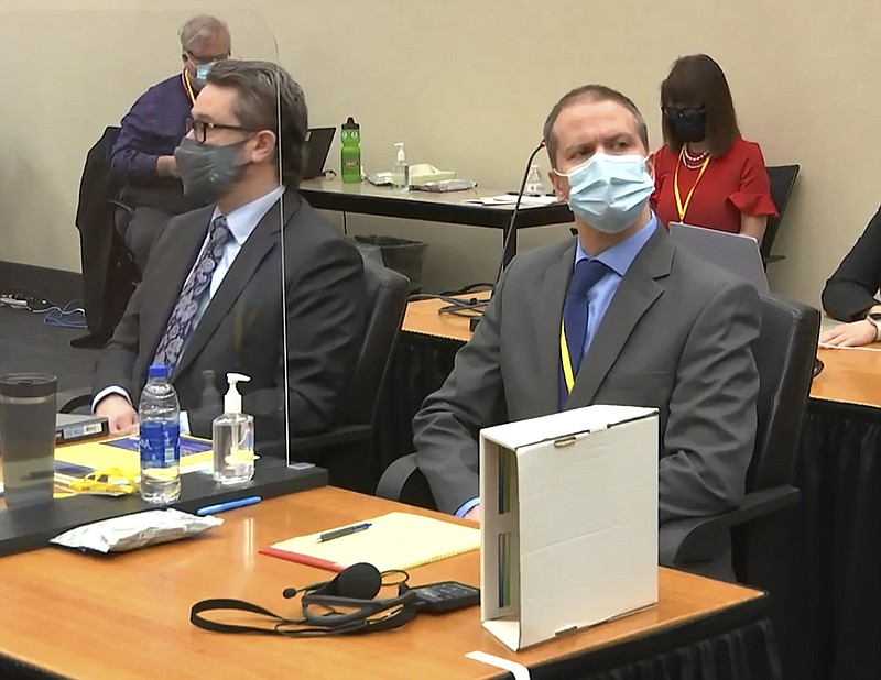 In this image from video, defense attorney Eric Nelson, left, and former Minneapolis police officer Derek Chauvin listen as Hennepin County Judge Peter Cahill presides over pre-trial motions prior to opening statements, Monday March 29, 2021, in the trial of Chauvin, in the May 25, 2020, death of George Floyd at the Hennepin County Courthouse in Minneapolis, Minn. (Court TV via AP, Pool)