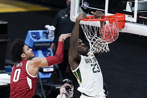 Baylor forward Jonathan Tchamwa Tchatchoua (23) dunks on Arkansas forward Justin Smith (0) during the first half of an Elite 8 game in the NCAA men's college basketball tournament at Lucas Oil Stadium, Monday, March 29, 2021, in Indianapolis. (AP Photo/Michael Conroy)