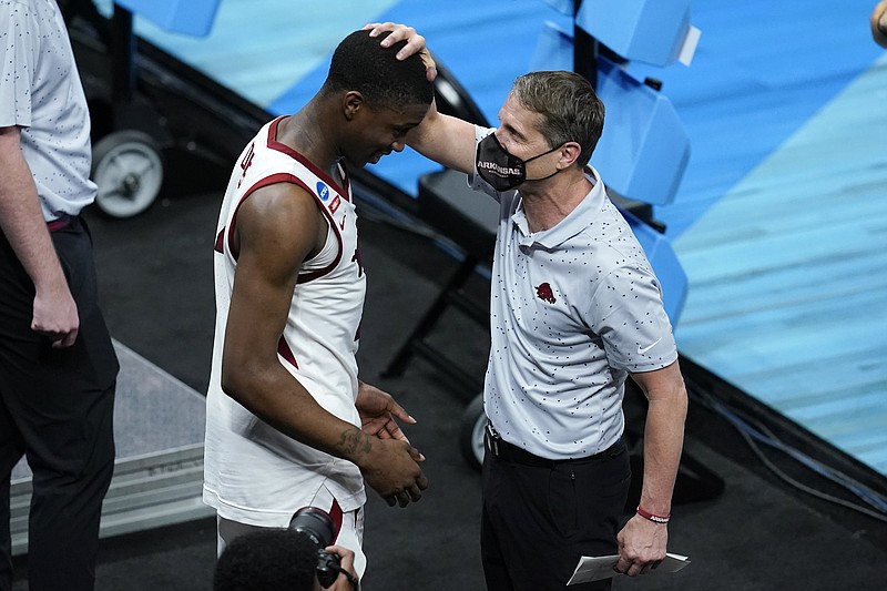 Arkansas head coach Eric Musselman, right, celebrates with guard Davonte Davis after a Sweet 16 game against Oral Roberts in the NCAA men’s college basketball tournament at Bankers Life Fieldhouse, Saturday in Indianapolis. Arkansas won, 72-70.