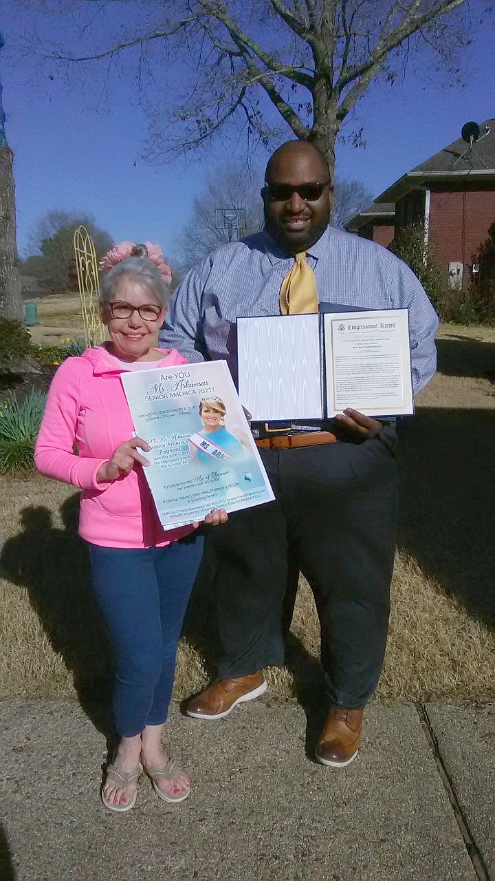 Patty Genovese, Arkansas Senior America administrator, receives a copy of Rep. Bruce Westerman’s (R-AR4) comments about the Ms. Arkansas Senior pageant in the Congressional Record from Westerman spokesperson Jason McGhee. (Contributed)