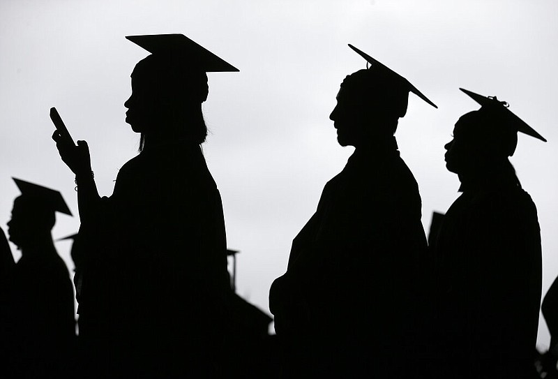 FILE - In this May 17, 2018, file photo, new graduates line up before the start of the Bergen Community College commencement at MetLife Stadium in East Rutherford, N.J. (AP Photo/Seth Wenig, File)