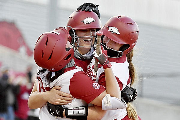 Arkansas batter Linnie Malkin (center) celebrates with teammates Aly Manzo (left) and Hannah McEwen (right) after hitting a two run home run against Mississippi State during an NCAA softball game on Friday, March 26, 2021, in Fayetteville. (AP Photo/Michael Woods) Arkansas batter Linnie Malkin (center) celebrates with teammates Aly Manzo (left) and Hannah McEwen (right) after hitting a two run home run against Mississippi State during an NCAA softball game on Friday, March 26, 2021, in Fayetteville. (AP Photo/Michael Woods)