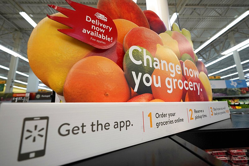 A sign promotes online and home delivery of groceries at a Walmart Supercenter in Houston in this Nov. 9, 2018, file photo. (AP/David J. Phillip)