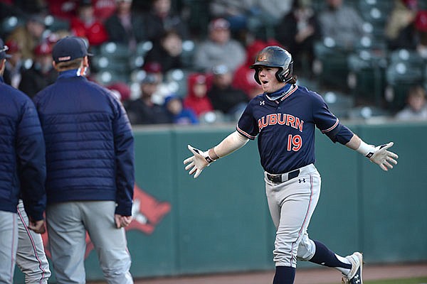 Auburn second baseman Brody Miller runs toward the dugout after hitting a home run during a game against Arkansas on Thursday, April 1, 2021, in Fayetteville.