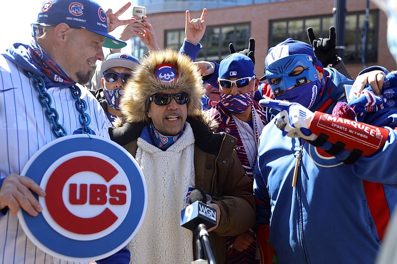 Chicago Cubs fans gather outside of Wrigley Field in Chicago for Thursday’s opener between the Cubs and the Pittsburgh Pirates. Fans are back at the ballpark after they were shut out during the regular season last year because of the coronavirus pandemic.
(AP/Shafkat Anowar)