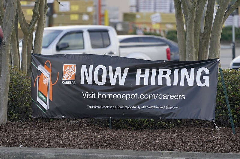 A roadside banner last week beckons to job applicants outside a Home Depot store in Hattiesburg, Miss. The number of Americans applying for unemployment benefits rose by 61,000 last week to 719,000.
(AP/Rogelio V. Solis)