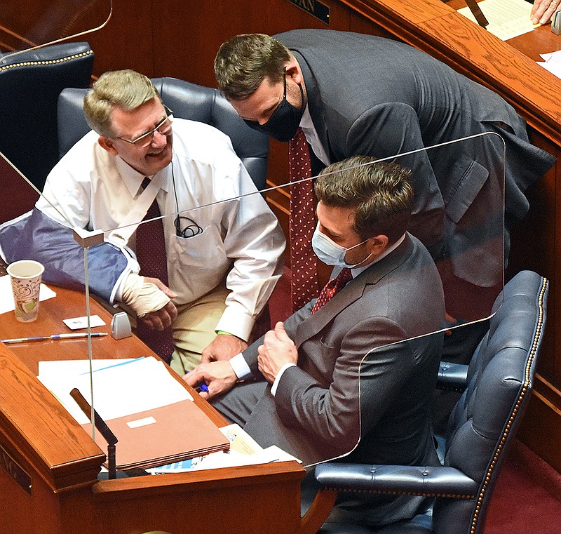 Sen. Bart Hester (center) confers Thursday with Sen. Ricky Hill (left), R-Cabot, and Sen. Jonathan Dismang, R-Beebe, during the Senate session. At Hester’ request, the Senate recalled a bill from the House on telemedicine policy changes to consider amending it.
(Arkansas Democrat-Gazette/Staci Vandagriff)