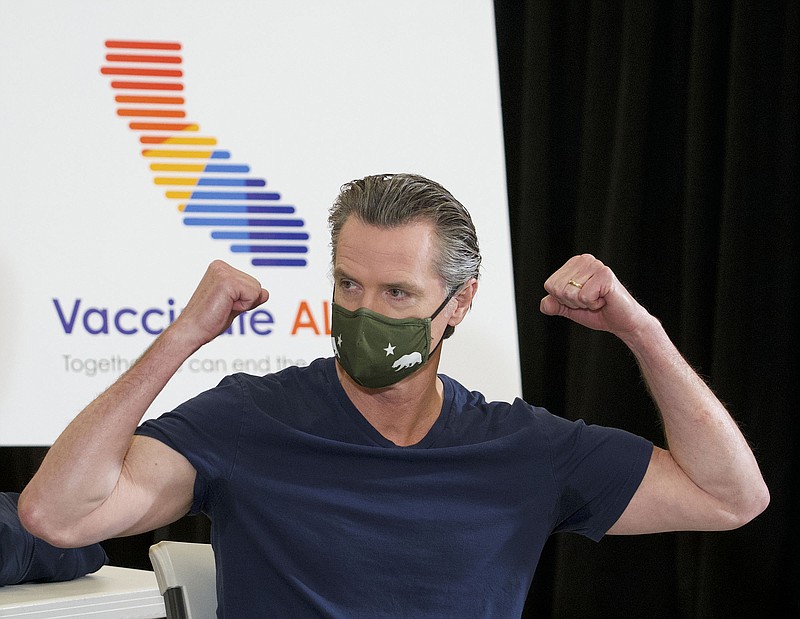 California Gov. Gavin Newsom celebrates Thursday in Los Angeles after being inoculated with the one-dose Johnson & Johnson vaccine administered by Dr. Mark Ghaly, the secretary of California Health and Human Services.
(AP/Damian Dovarganes)