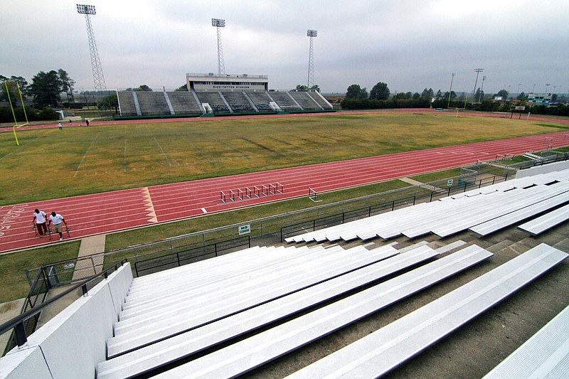 Student managers carry track starting blocks after practice on the track at Rice-Totten Stadium at Mississippi Valley State University in Itta Bena, Miss., in this Nov. 3, 2010, file photo. (AP/Rogelio V. Solis)