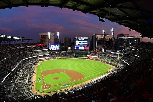 Ground crews prepare the field at Sun Trust Park, now known as Truist Park, ahead of Game 3 of Major League Baseball's National League Division Series between the Atlanta Braves and the Los Angeles Dodgers in Atlanta in this Oct. 7, 2018, file photo. (AP/John Amis)