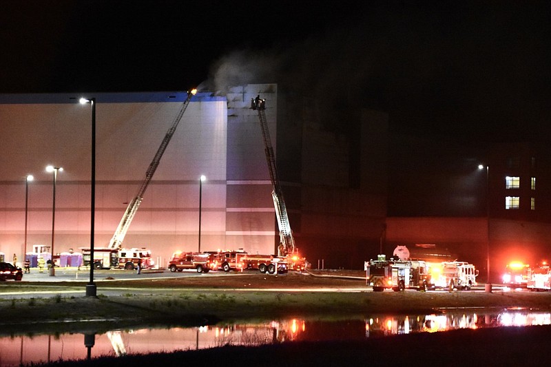 Firefighters with the Little Rock Fire Department work to put out a fire at the Amazon fulfillment center on Zeuber Road near the Port of Little Rock on Friday, April 2, 2021. (Arkansas Democrat-Gazette/Staci Vandagriff)