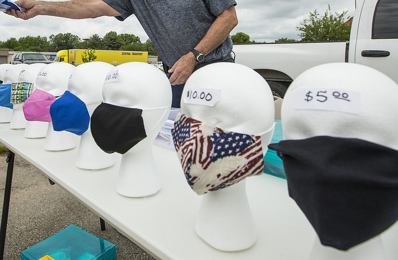 Masks for sale Thursday, May 14, 2020, in a vacant parking lot next to Harbor Freight Tools in Rogers..(NWA Democrat-Gazette File Photo/Ben Goff)