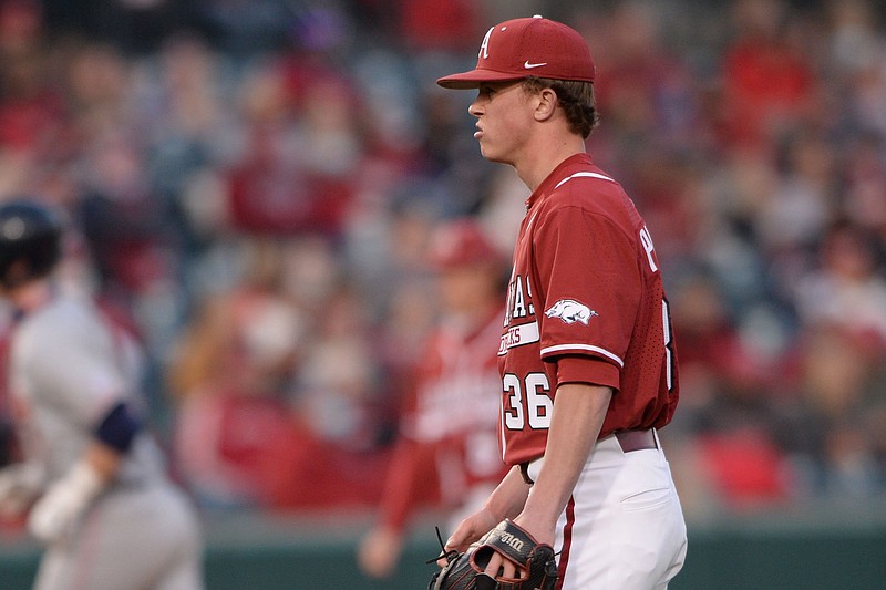 Arkansas reliever Peyton Pallette reacts Friday, April 2, 2021, as Auburn second baseman Steven Williams rounds the bases after hitting a solo home run during the fourth inning of play at Baum-Walker Stadium in Fayetteville.