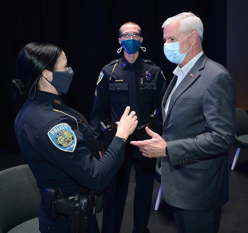 Rep. Steve Womack (right) speaks Thursday with Natalie Eucce (left) and Seay Floyd, both officers with the Fayetteville Police Department, before awarding them the attorney general’s award for distinguished service in policing for their actions after fellow officer Stephen Carr was killed Dec. 7, 2019. Womack made the presentation at the Fayetteville Public Library and then toured the library’s new addition.
(NWA Democrat-Gazette/Andy Shupe)