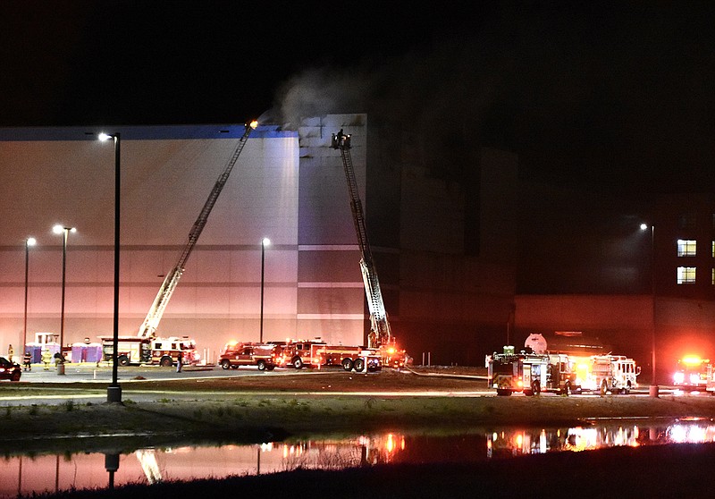 Little Rock firefighters work to extinguish a fire Friday night at the Amazon fulfillment center that is under construction on Zeuber Road at the Little Rock Port. More photos at arkansasonline.com/43amazonfire/.
(Arkansas Democrat-Gazette/Staci Vandagriff)