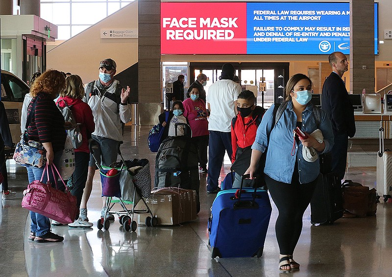 Travelers wait in line to check in for flights Friday at Bill and Hillary Clinton National Airport/Adams Field in Little Rock as the holiday weekend starts.
(Arkansas Democrat-Gazette/Thomas Metthe)