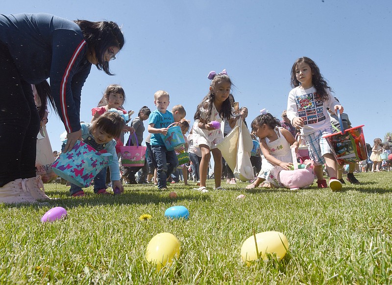 Youngsters dash through Ward Nail Park in Lowell during the city’s community Easter egg hunt in 2019. As Arkansas churches reintroduce or continue in-person worship services in some capacity, faith leaders are determining what worship of Christ’s resurrection will look like on Sunday, the second consecutive Easter of the covid-19 pandemic.
(NWA Democrat-Gazette/Flip Putthoff)