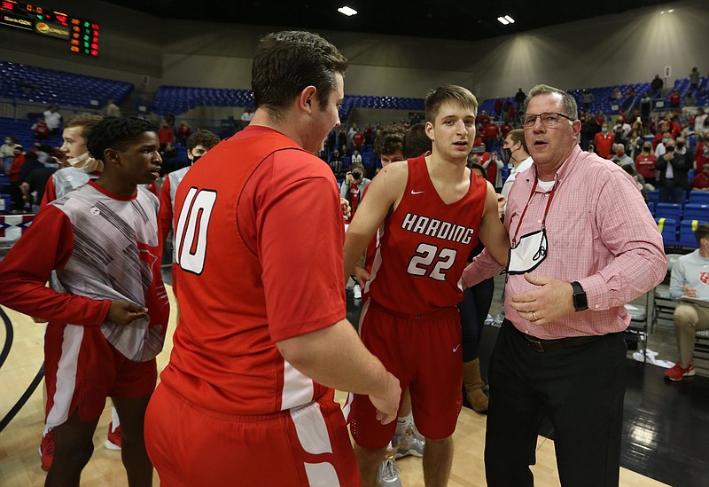 Harding Academy head coach Brad Francis  (right) celebrates with his players after Harding's 42-38 win over Mayflower in the Class 3A boys state championship game on Friday, March 18, 2021, at Bank OZK Arena in Hot Springs. .(Arkansas Democrat-Gazette/Thomas Metthe)