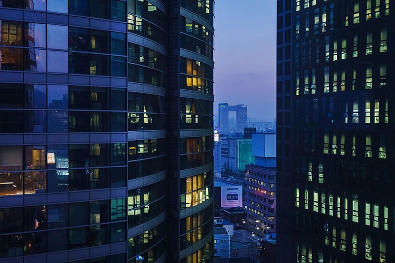 Apartment buildings in Seoul light up in the evening as people get home from work. The South Korean capital’s 10 million people are  packed into a density that is 60% higher than New York City.
(Los Angeles Times/TNS/Marcus Yam)