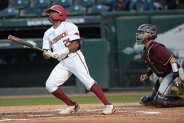Arkansas center fielder Christian Franklin hits an RBI double to score first baseman Brady Slavens on Tuesday, April 6, 2021, during the third inning of play against UALR at Baum-Walker Stadium in Fayetteville.