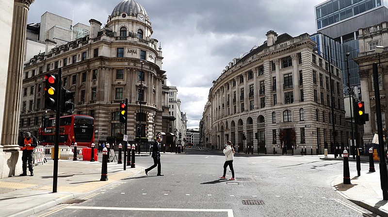 A street at Bank junction in London is quiet Tuesday. When the pandemic struck, about 540,000 workers vacated London’s fi nancial hub almost overnight. A year later, most haven’t returned.
(AP/Alastair Grant)