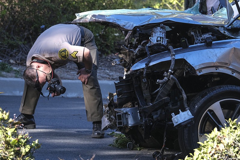 A law enforcement officer photographs the damaged SUV that Tiger Woods crashed in the Rancho Palos Verdes suburb of Los Angeles on Feb. 23. Woods suffered severe leg injuries in the crash. On Wednesday, Sheriff Alex Villanueva reported the cause of the crash was excessive speed and Woods’ loss of control behind the wheel.
(AP/Ringo H.W. Chiu)