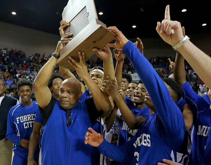 Forrest City Coach Dwight Lofton celebrates with his players after the Mustangs won the Class 5A boys basketball state championship in 2016. Lofton, the Mustangs’ coach for 25 years, died unexpectedly Wednesday night at age 60.
(Democrat-Gazette file photo)