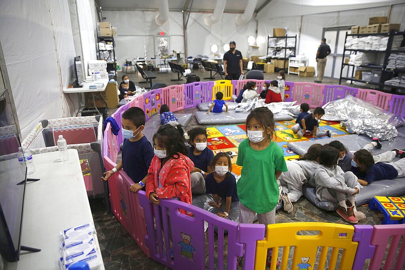 Young unaccompanied migrants, from ages 3 to 9, watch television inside a playpen at the U.S. Customs and Border Protection facility, the main detention center for unaccompanied children in the Rio Grande Valley, in Donna, Texas, in this March 30, 2021, file photo. (AP/Dario Lopez-Mills, Pool, File)
