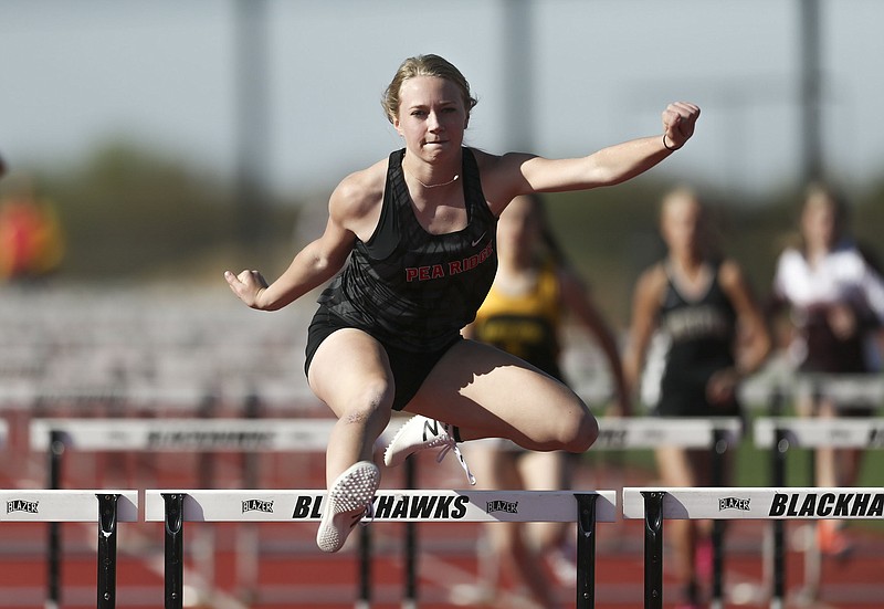 Blakelee Winn runs a 100 meter hurdle, Thursday, April 8, 2021 during a track meet at Pea Ridge High School in Pea Ridge. Check out nwaonline.com/210409Daily/ for today's photo gallery. .(NWA Democrat-Gazette/Charlie Kaijo)