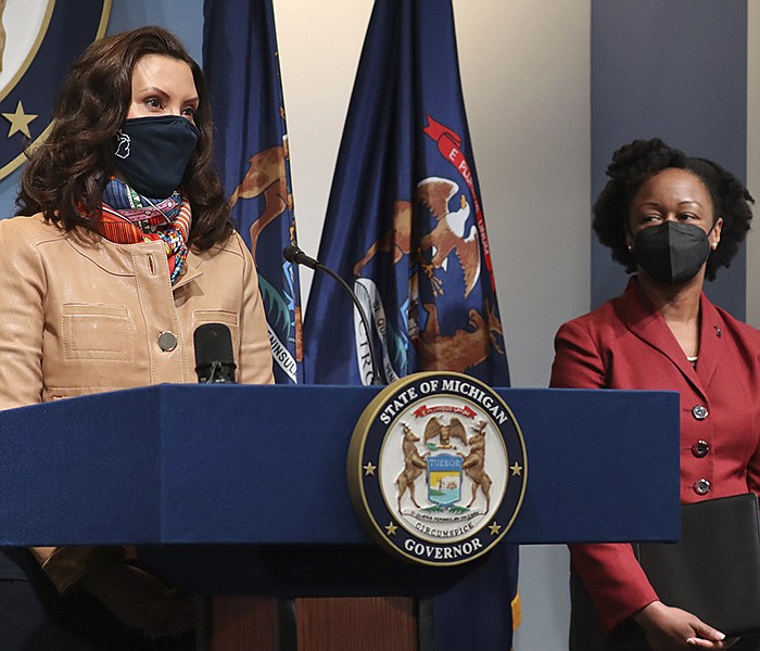 In this photo provided by the Michigan Office of the Governor, Gov. Gretchen Whitmer addresses the state as Michigan Department of Health and Human Services Chief Medical Executive Dr. Joneigh Khaldun, right, listens in on Friday, April 9, 2021, in Lansing, Mich. “Today it’s Michigan and the Midwest,” Michigan Gov. Gretchen Whitmer said Friday in Lansing, Mich., in calling for more vaccine doses for her state. “Tomorrow, it could be another section of our country.” More photos at arkansasonline.com/410covid19/.
(AP/Michigan office of the governor)(Michigan Office of the Governor via AP)