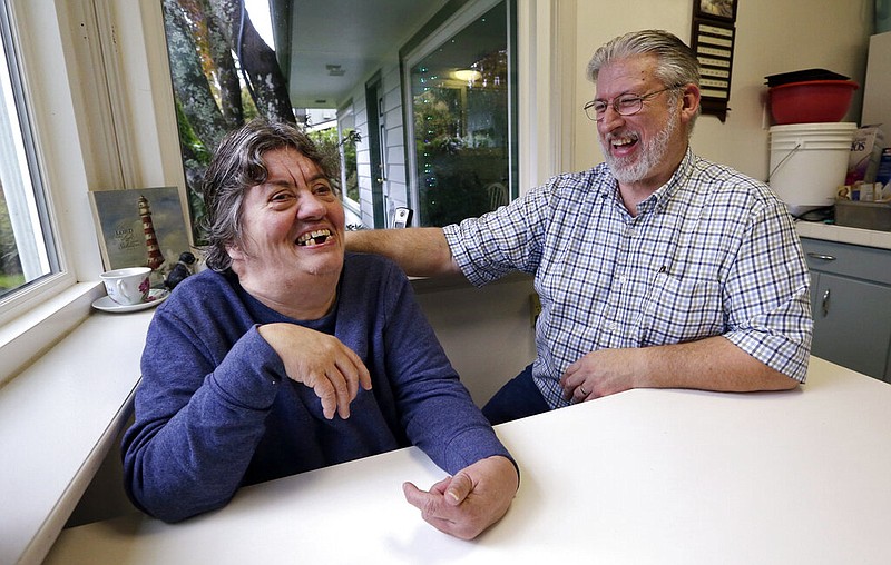 Brad Boardman (right) shares a laugh with sister-in-law Beth Wright, for whom he is a caregiver, at their home in Everett, Wash., in this Oct. 18, 2016, file photo. (AP/Elaine Thompson)