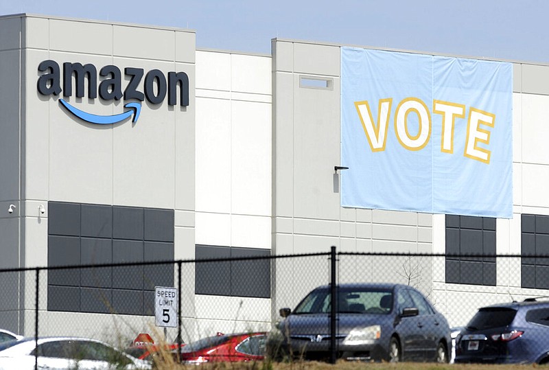 FILE - In this Tuesday, March 30, 2021 file photo, a banner encouraging workers to vote in labor balloting is shown at an Amazon warehouse in Bessemer, Ala. (AP/Jay Reeves, File)