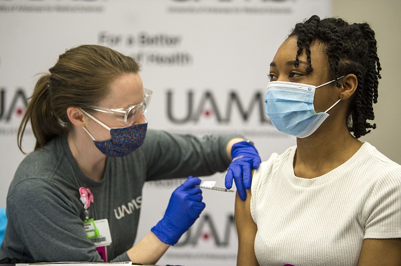 Nurse Karen Donaghue, left, gives a dose of the covid vaccine to Kaylynn Richardson during a mass vaccine clinic by UAMS at Simmons Bank Arena in North Little Rock on Saturday, April 10, 2021. (Arkansas Democrat-Gazette/Stephen Swofford)